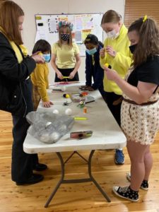 Girls making bee craft item