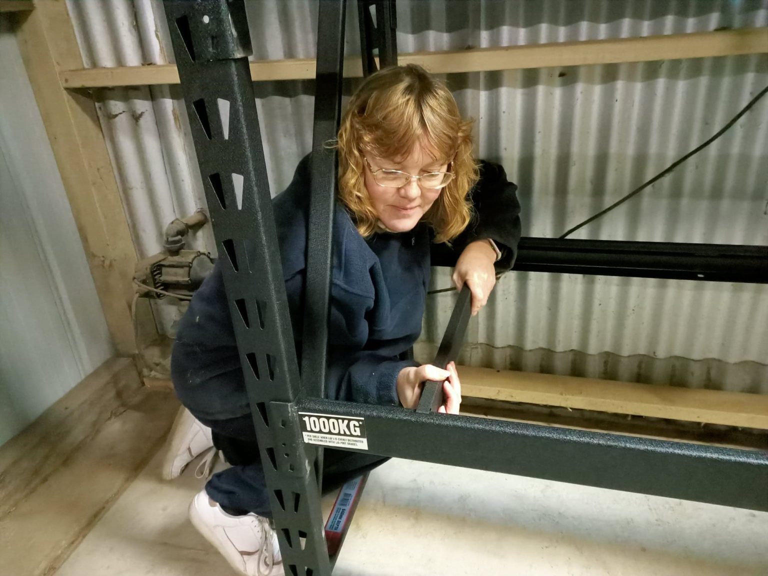 Lady attaching bars on shelves