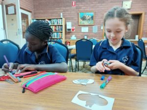 Girls making craft bees
