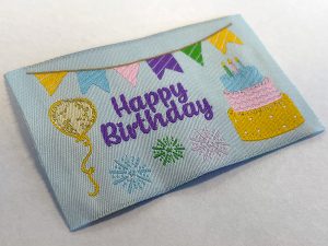 Cake and balloons on badge
