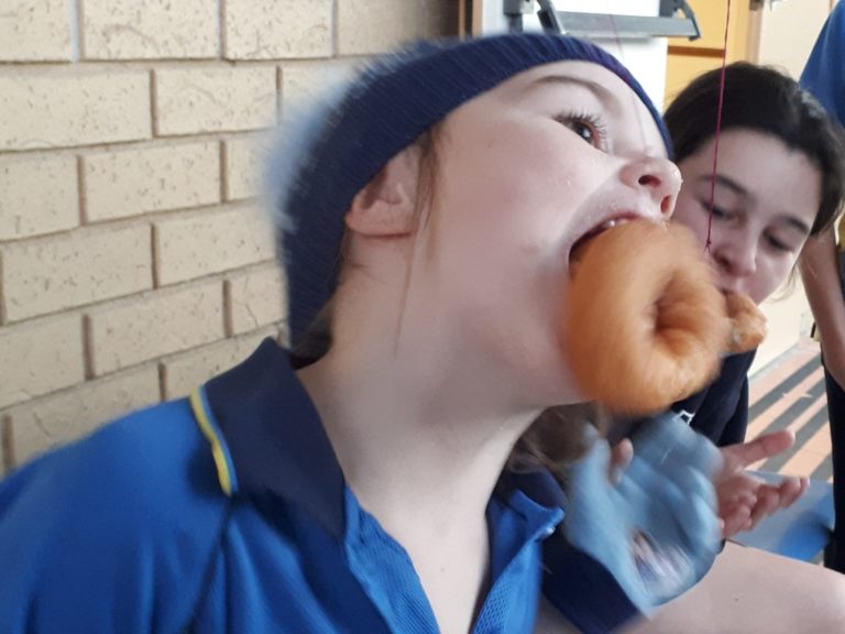 Doughnuts hanging on string